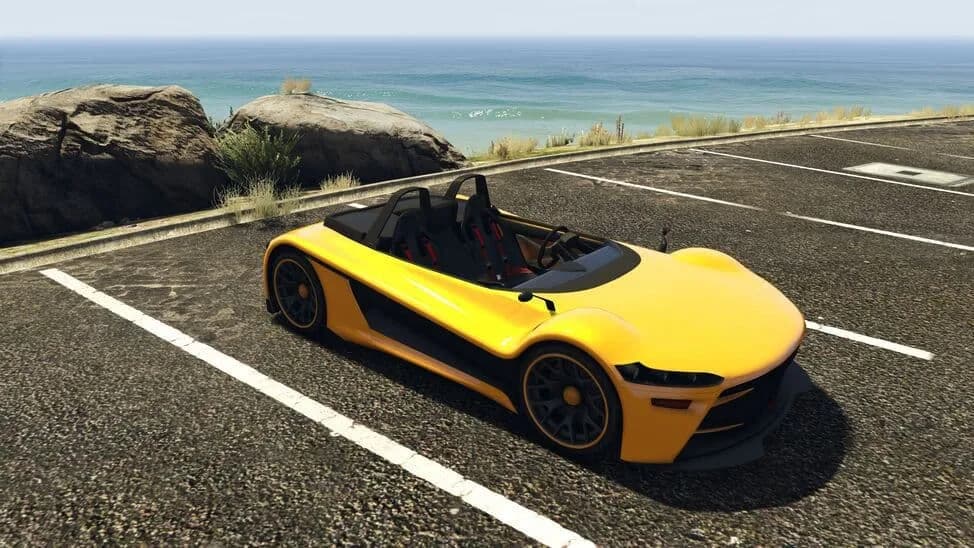 The Hijak Ruston, a yellow open-top lightweight sports car, parked by the coast, in GTA Online.