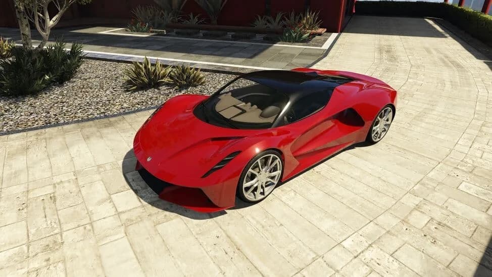 The Ocelot Virtue, a red electric hypercar with a black roof, parked on a paved courtyard, in GTA Online.