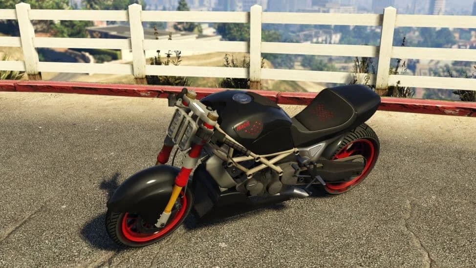 The Principe Diabolus Custom, a black stripped streetfighter motorcycle with red wheels, parked by a white fence, in GTA Online.