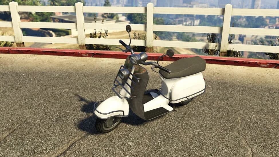 The Pegassi Faggio Mod, a white and black retro scooter with a front rack, parked by a white fence, in GTA Online.