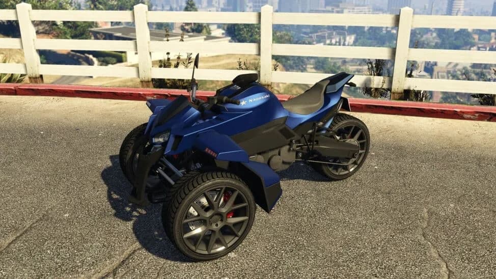 The Nagasaki Stryder, a blue three-wheeled reverse trike, parked by a white fence, in GTA Online.