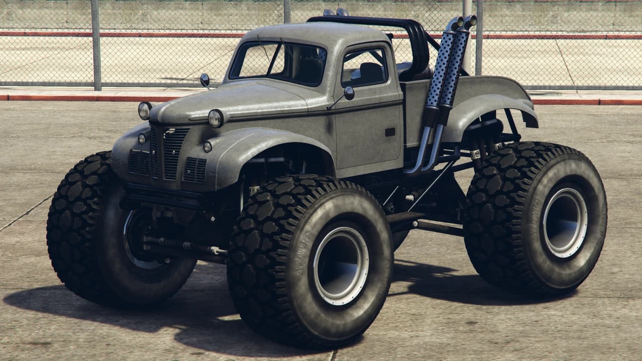 A grey Bravado Apocalypse Sasquatch, a vintage pickup cab on monster-truck axles, front three-quarter view.