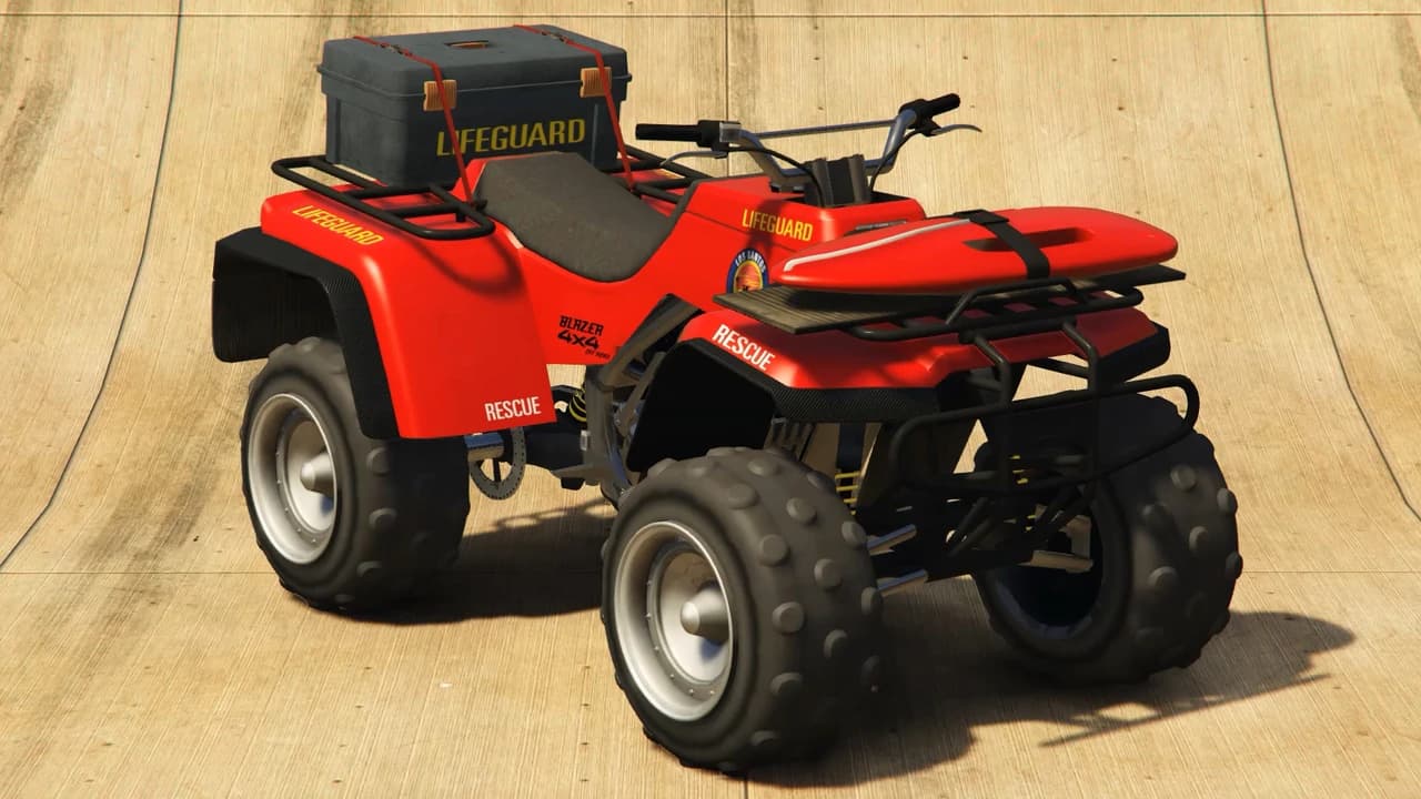 A red Nagasaki Blazer Lifeguard quad bike carrying a rescue board and equipment case, front three-quarter view.