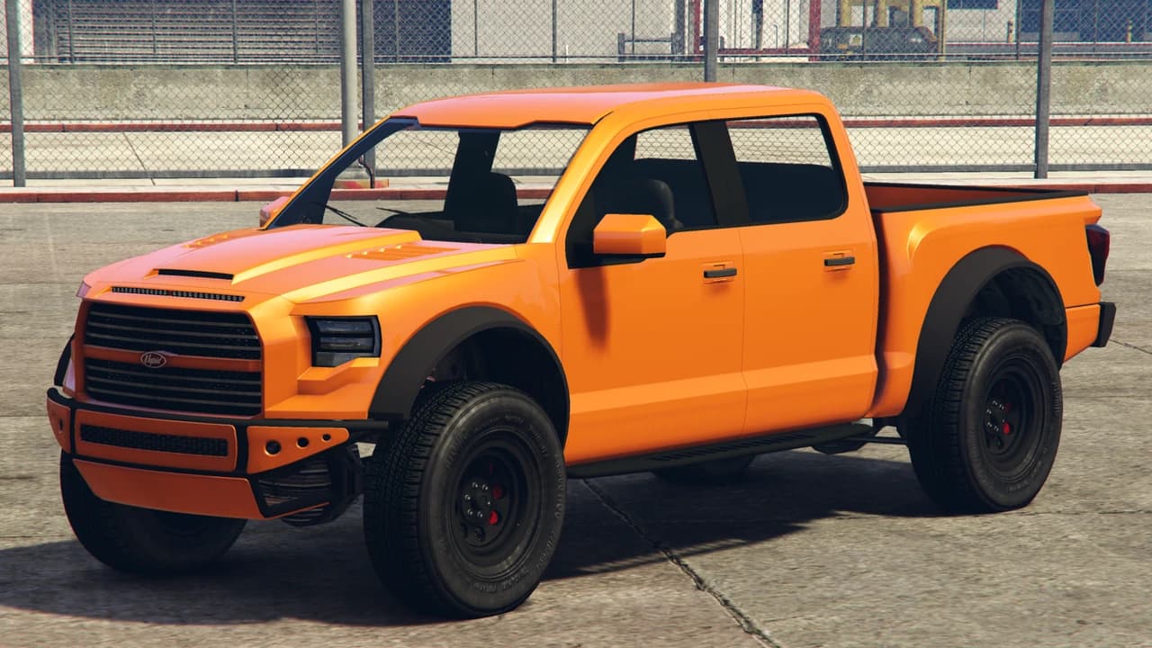 An orange Vapid Caracara 4x4 pickup, front three-quarter view.