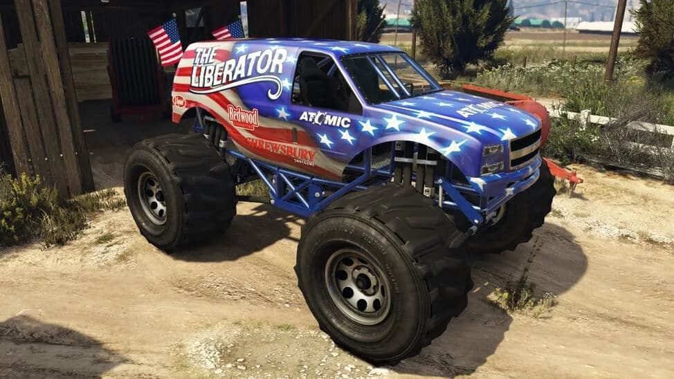 The Vapid Monster, a monster truck in a stars-and-stripes livery, parked by a barn, in GTA Online.