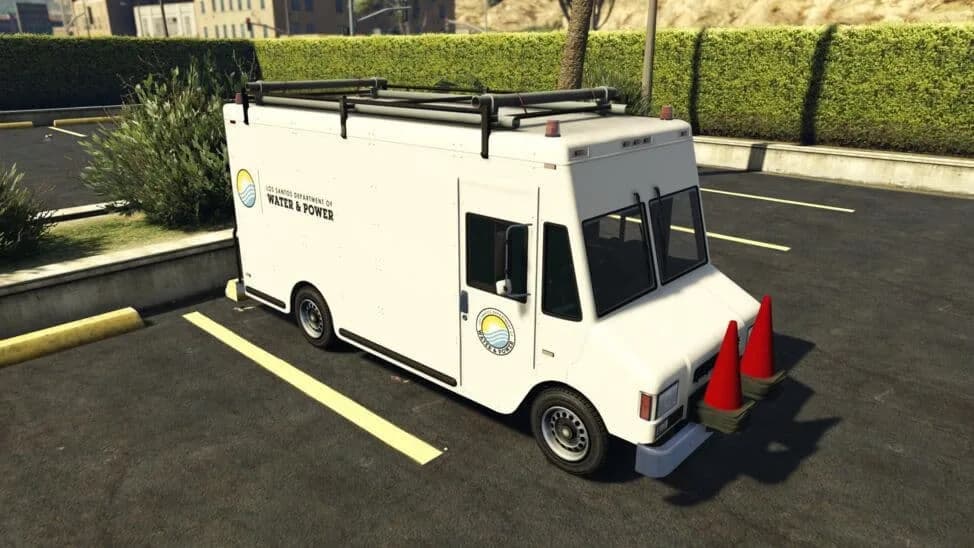 The Brute Boxville (LSDWP), a white utility step van in the water and power department's livery with a roof rack and cones, parked in a car park, in GTA Online.