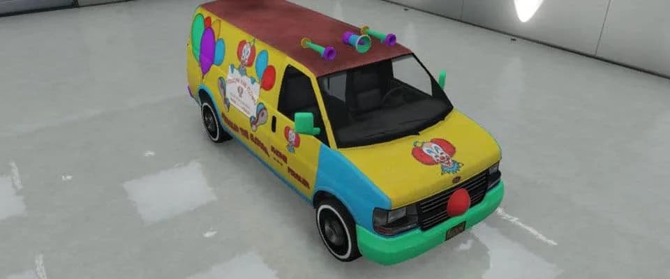 The Vapid Clown Van, a yellow and blue van covered in clown paintwork with a red nose and roof horns, in a white garage, in GTA Online.