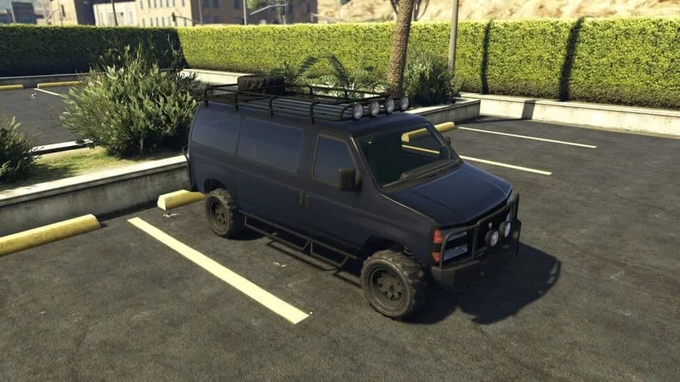 The Bravado Rumpo Custom, a black off-road van with a roof rack and spotlights, parked in a car park, in GTA Online.