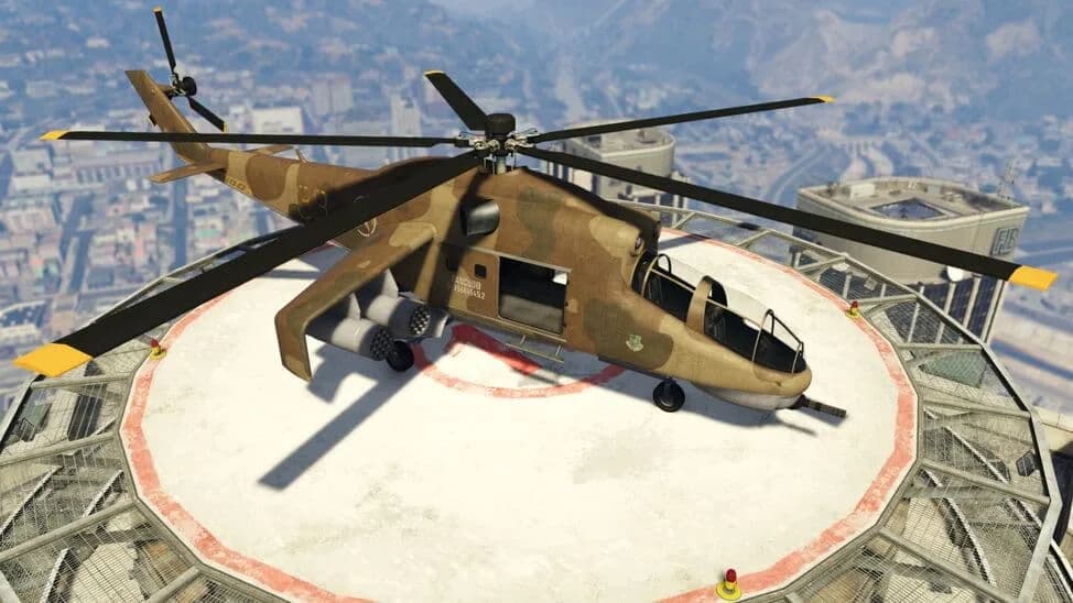 The Savage, a desert-camouflage attack helicopter, parked on a rooftop helipad above the city, in GTA Online.