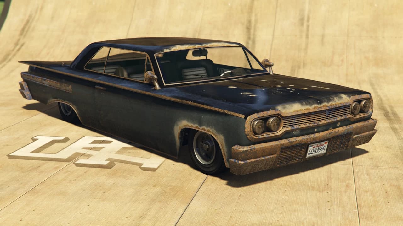 A weathered dark blue Declasse Voodoo lowrider, front three-quarter view.