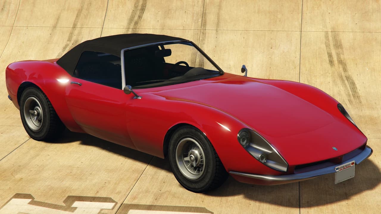 A red Grotti Stinger with the black soft top raised, front three-quarter view.