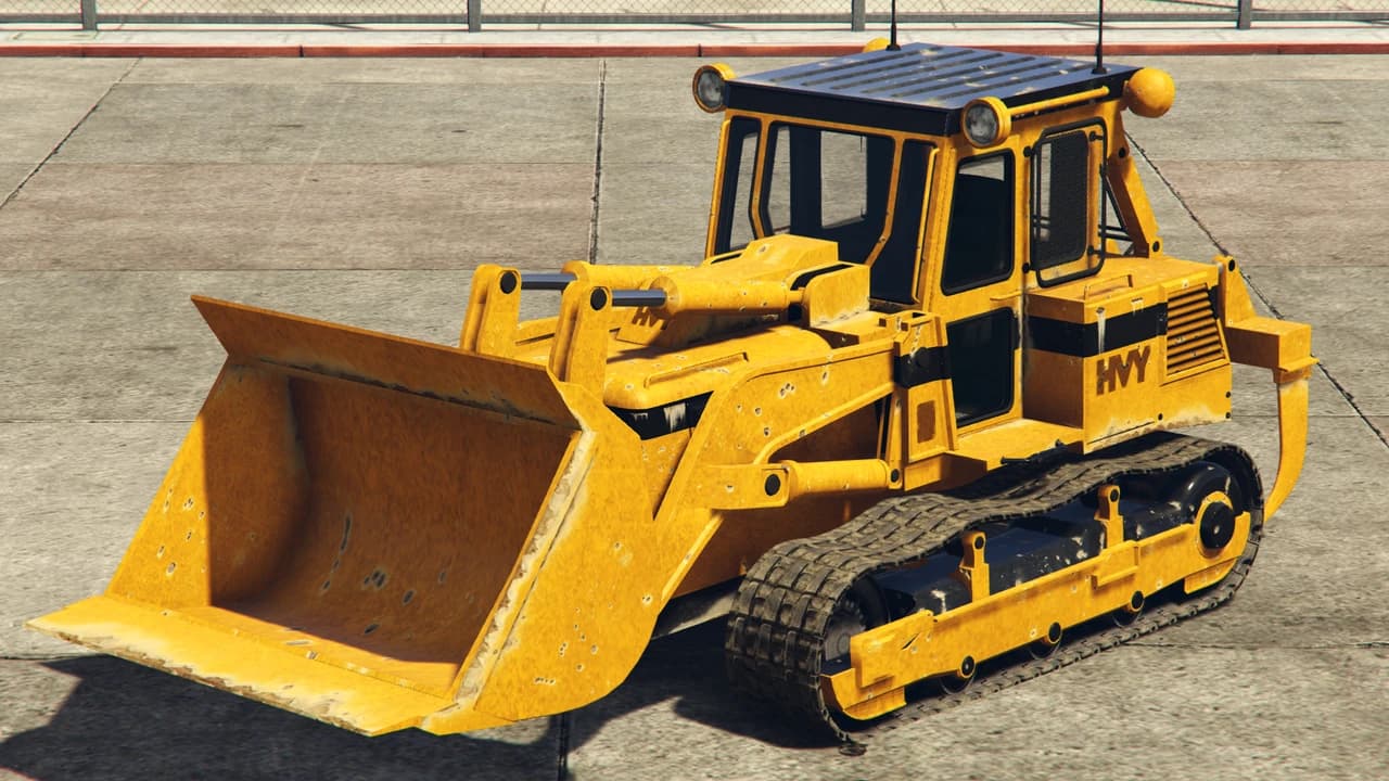 A yellow HVY Dozer track loader with HVY lettering on the engine cover, front three-quarter view.