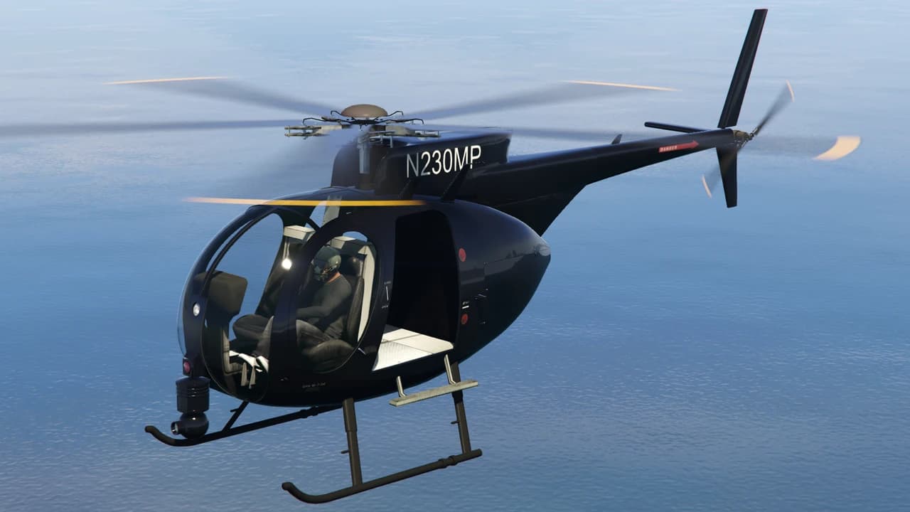 A black Buzzard light helicopter in flight over water, carrying the tail number N230MP.