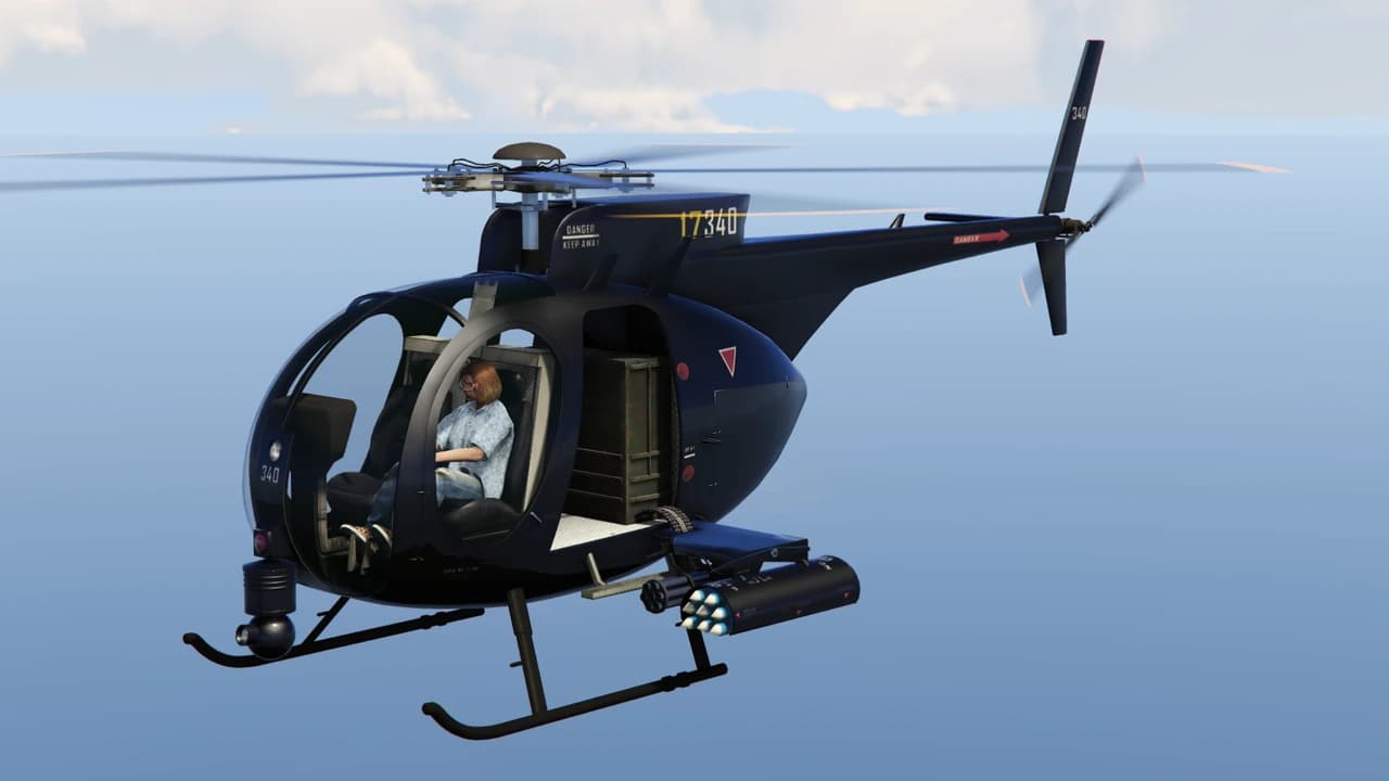 A navy Buzzard Attack Chopper in flight, with a minigun pod on each side.