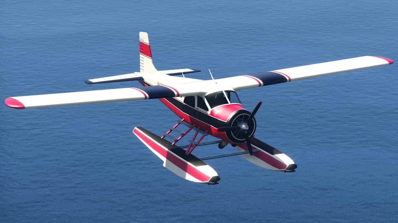 A red, white and black Mammoth Dodo floatplane in flight over water.