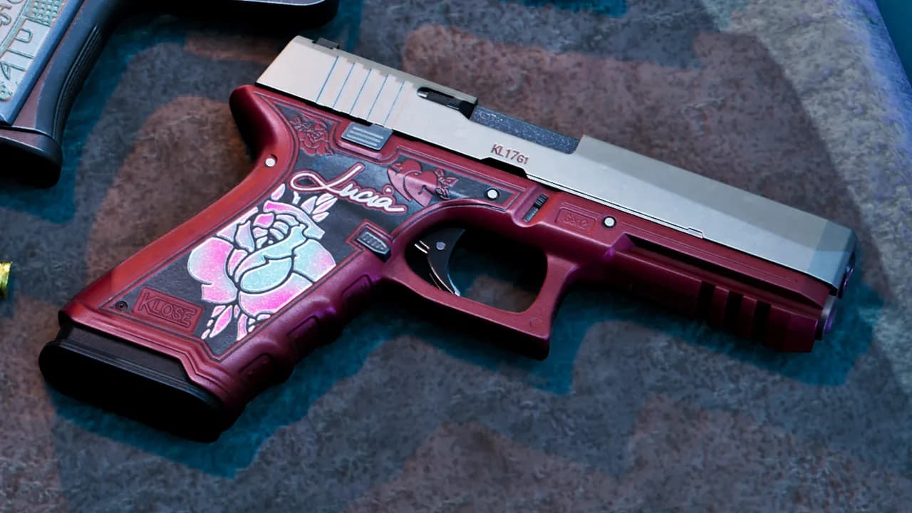 Lucia's personalised Klose K17 pistol, with a red frame, a silver slide and a grip decorated with a pink rose and her name, lying on stone; the grip of Jason's pistol is in the upper corner, in GTA VI.
